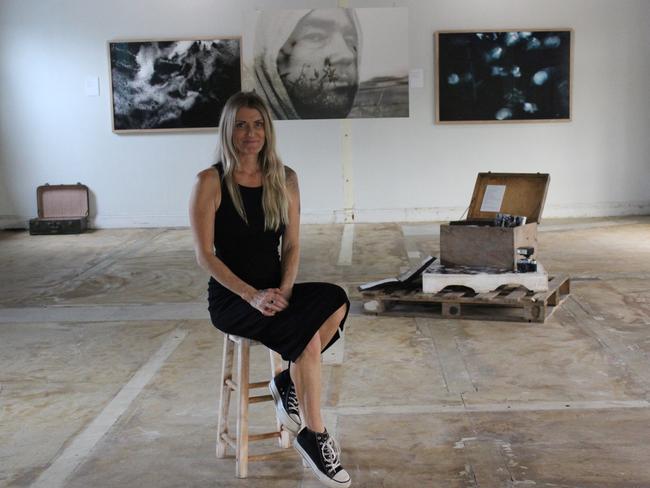 Leah McLean with an image of her late husband, Paul, hanging in the back. Picture: ANDREW KACIMAIWAI