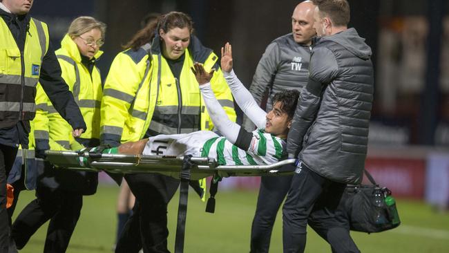 Celtic’s Daniel Arzani is carried off after injuring his ACL. Picture: Jeff Holmes/PA