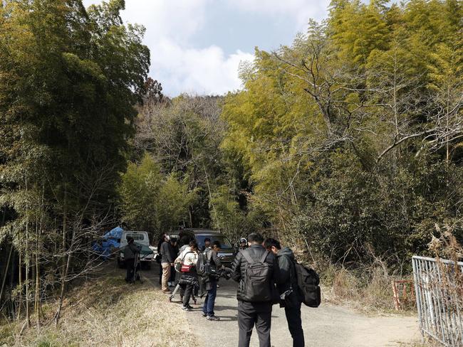 Journalists gather near the site where a body part believed to be of a missing woman was found in Osaka, western Japan. Picture: Yuki Sato/Kyodo News/AP