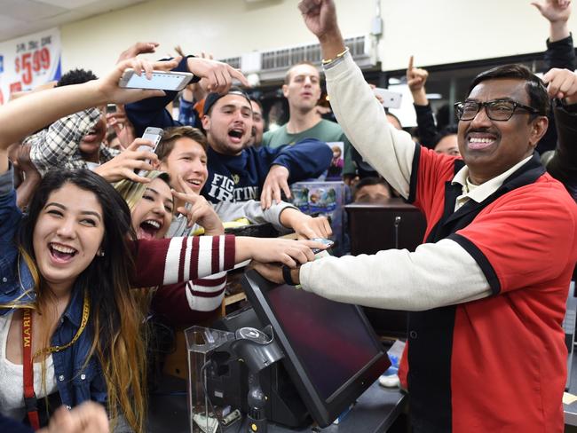 7-Eleven store clerk M. Faroqui celebrates with customers after learning the store sold the only winning Powerball ticket on Wednesday, Jan. 13, 2016 in Chino Hills, Calif. One winning ticket was sold at the store located in suburban Los Angeles said Alex Traverso, a spokesman for California lottery. The identity of the winner is not yet known. (Will Lester/The Sun via AP) MANDATORY CREDIT
