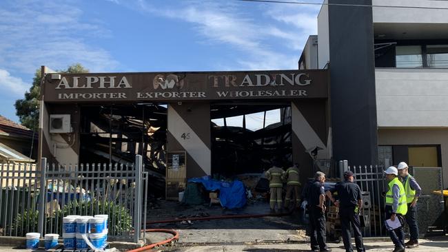 Engineers and police inspect the damage at Alpha Trading, the day after the fire. Picture: Kirra Grimes