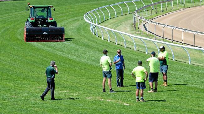 Officials inspect Ipswich racetrack last Wednesday after the meeting was abandoned early. Picture: Rob Williams