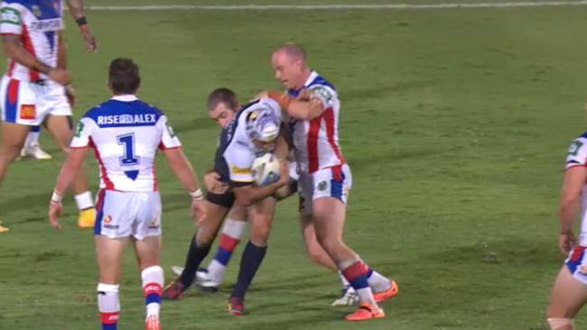 Thurston cops some rough treatment from Knights Chris Houston and Beau Scott.