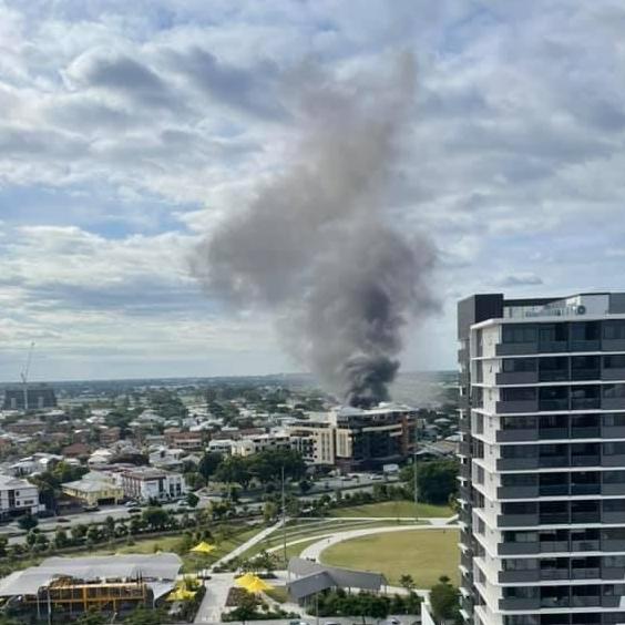 Smoke billows across Brisbane from a large house fire in Hamilton. Picture: Glenn Williams