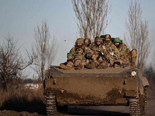 Ukrainian servicemen sit on a BMP military vehicle as they move towards Bakhmut in the region of Donbas, March 2023. The region has been one of the most heavily fought-over since Russia’s invasion. Picture: Aris Messinis/AFP