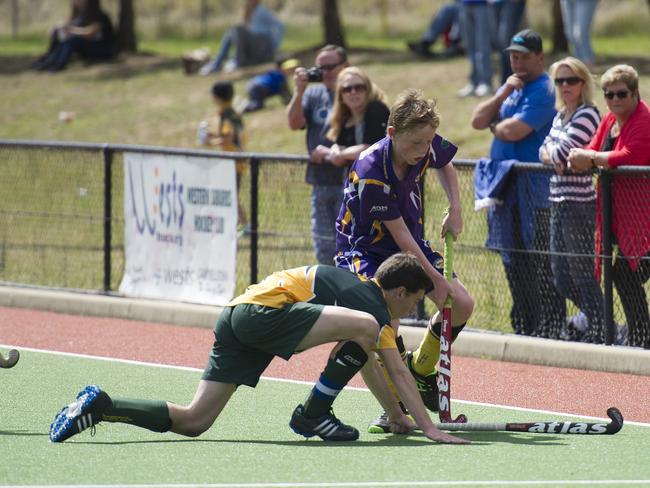 Macarthur Chronicle - Pictured: Action photographs - Ingleburn Bulldogs (green yellow) versus Harrington Park Hurricanes (purple) - Macarthur District Juniors hockey finals 2014 held at Millwood Avenue, Narellan NSW Australia