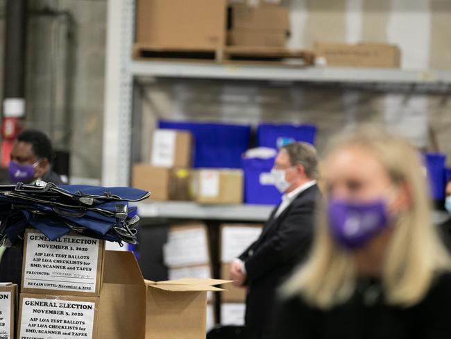 Members of an adjudication review panel look over scanned absentee ballots at the Fulton County Election Preparation Center. Picture: Getty Images.