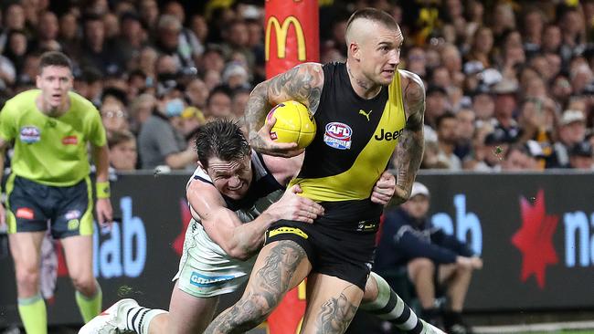 Dustin Martin evades Patrick Dangerfield before booting his fourth goal in Saturday’s Grand Final. Picture: Sarah Reed