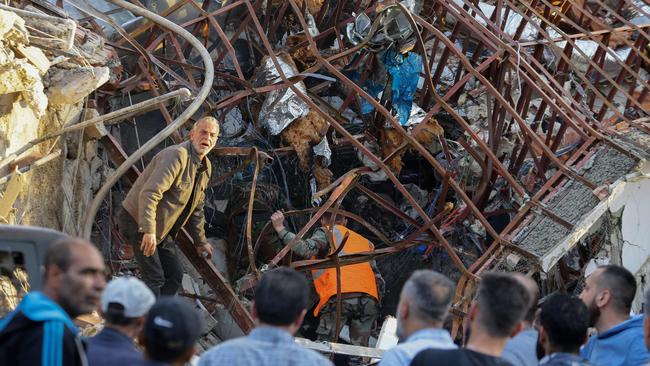 Emergency and security personnel inspect the rubble at the site of strike on a building that reportedly served as the IRGC military headquarters in Damascus. Picture: AFP.