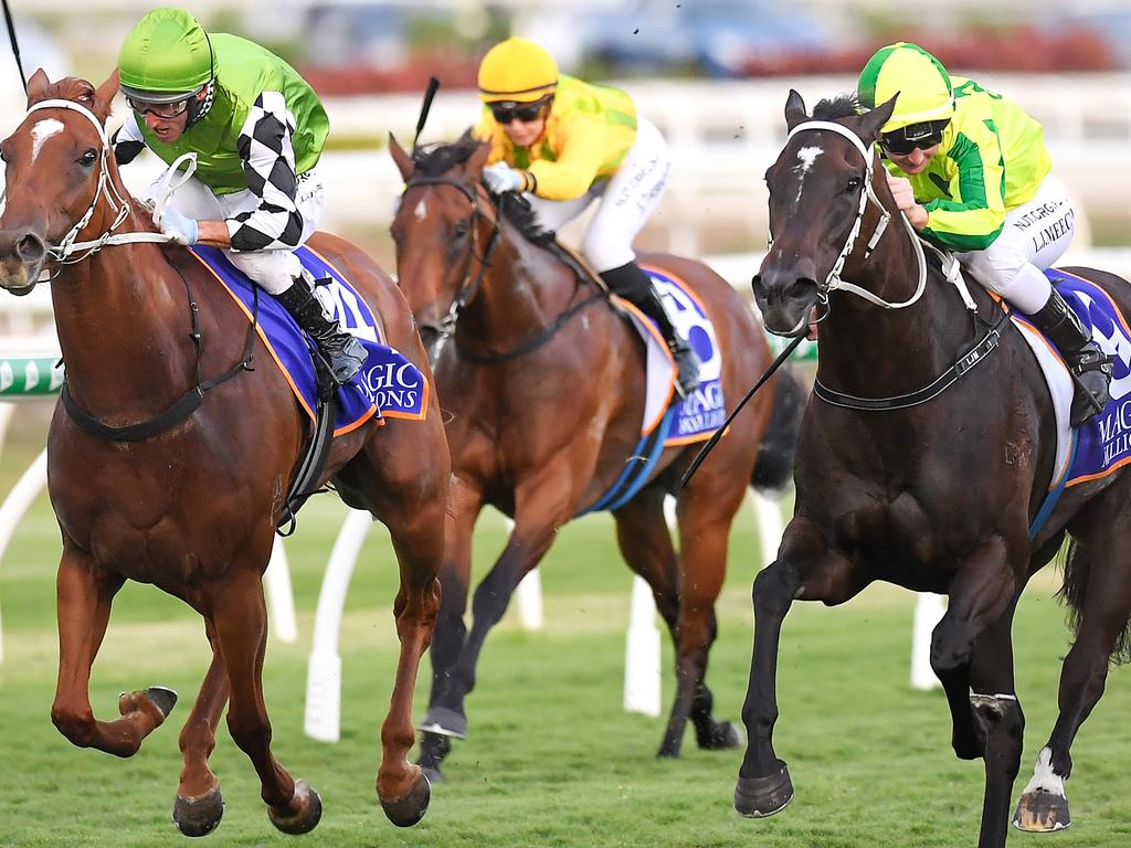 Damien Oliver rides Tahitian Dancer (left) to victory in the Nudgee Stakes.