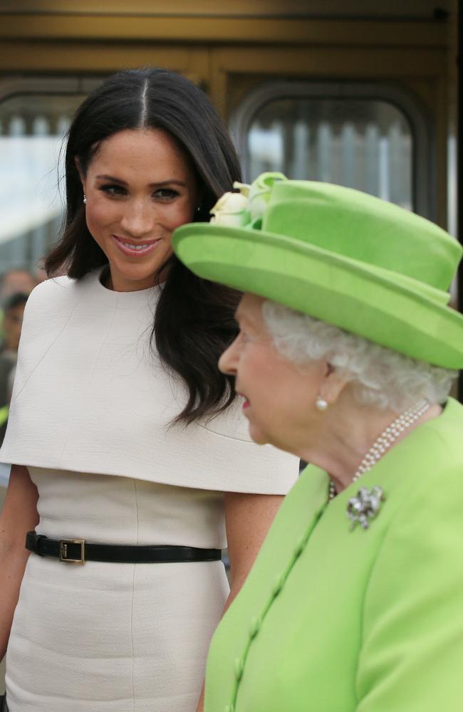 Meghan Markle looks relaxed with Queen Elizabeth II at Runcorn Station. Picture: Getty