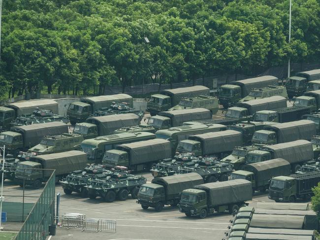 Trucks and armoured personnel carriers near the Hong Kong border. Picture: AFP