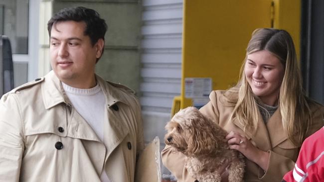 Brittany Higgins and David Sharaz cuddle their cavapoodle dog Kingston and carry their cat Clover after the animals cleared quarantine at the Bordeaux-Merignac airport in France in December 2023. Picture: Jacquelin Magnay