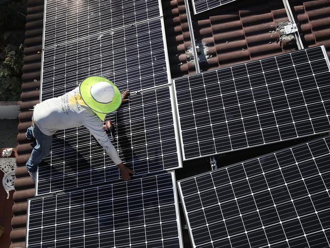 PALMETTO BAY, FL - JANUARY 23: Roger Garbey, from the Goldin Solar company, installs a solar panel system on the roof of a home a day after the Trump administration announced it will impose duties of as much as 30 percent on solar equipment made abroad on January 23, 2018 in Palmetto Bay, Florida. Daren Goldin the owner of the company said, 'the tariffs will be disruptive to the American solar industry and the jobs they create.'   Joe Raedle/Getty Images/AFP == FOR NEWSPAPERS, INTERNET, TELCOS & TELEVISION USE ONLY ==