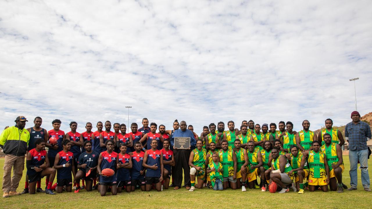 Players and coaching staff who took part in the inaugural game on the new surface gather for a photograph. Picture: Emma Murray