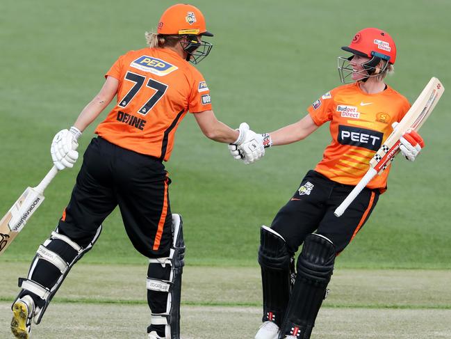 LAUNCESTON, AUSTRALIA - OCTOBER 24: Beth Mooney of the Perth Scorchers shakes the hand of her captain  Sophie Devine after she reached her 50th run during the Women's Big Bash League match between the Perth Scorchers and the Sydney Thunder at University of Tasmania Stadium, on October 24, 2021, in Launceston, Australia. (Photo by Sarah Reed/Getty Images)