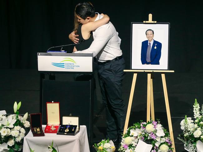 Pamela Jape is embraced by her nephew Chris after eulogising her father, prominent Darwin businessman Jape Kong Su  at a public memorial at the Convention Centre.Picture: Glenn Campbell