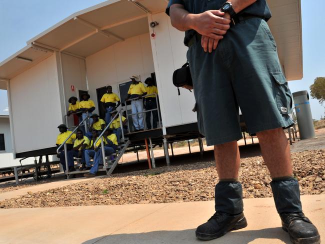 A guard stands in front of the new facility for inmates at the Barkly work camp prison in Tenant Creek. The newly opened facility is the first in the Northern Territory were prisoners go out to work in the community.