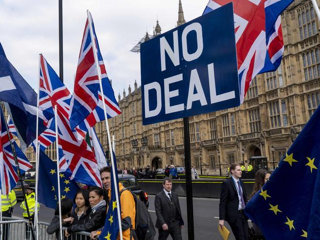 Anti-Brexit activists display the Union and EU flags as they demonstrate outside the Houses of Parliament in Westminster, London on March 28, 2019. - Faced with losing all control over the Brexit process, British Prime Minister Theresa May looks to have played her final card by announcing she will step down if MPs approve her Brexit deal. (Photo by Niklas HALLE'N / AFP)