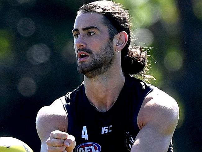 SUNSHINE COAST, AUSTRALIA - AUGUST 05: Brodie Grundy gets a handball away during a Collingwood Magpies AFL training session at Maroochydore Multi Sports Complex on August 05, 2020 in Sunshine Coast, Australia. (Photo by Bradley Kanaris/Getty Images)