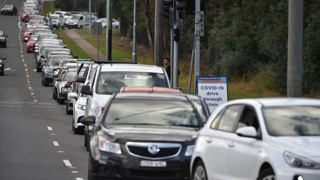 People queue up in their vehicles for a COVID-19 test at a testing station at the Crossroads Hotel. Picture: AFP