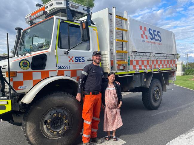Forbes SES volunteer Ryan Jones with the pregnant woman who became trapped in floodwaters after her water broke. Picture: SES NSW