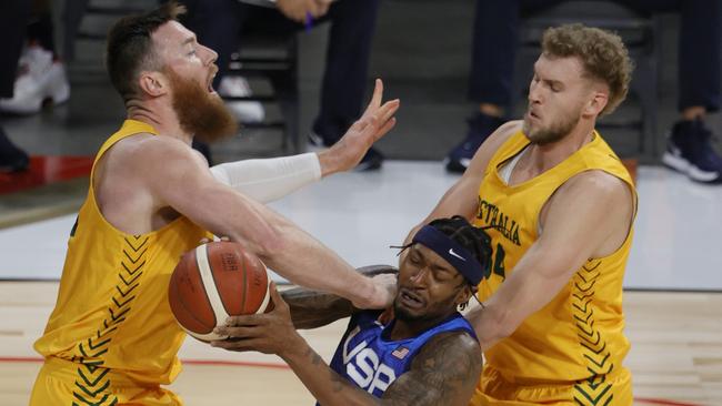 LAS VEGAS, NEVADA - JULY 12: Bradley Beal #4 of the United States drives into Aron Baynes #12 of the Australia Boomers as Jock Landale #34 of the Boomers defends during an exhibition game at Michelob Ultra Arena ahead of the Tokyo Olympic Games on July 12, 2021 in Las Vegas, Nevada.   Ethan Miller/Getty Images/AFP == FOR NEWSPAPERS, INTERNET, TELCOS & TELEVISION USE ONLY ==