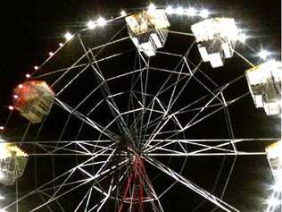 NO JOY: The ferris wheel showing the missing carriage, top left, at the Bluesfest site. Picture: Alex Cram