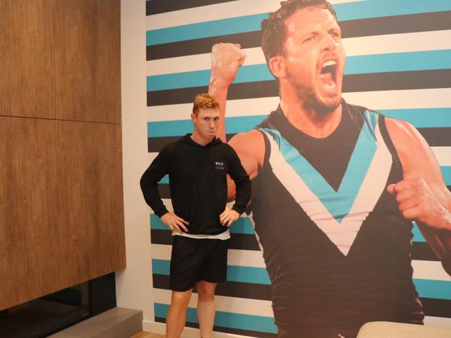 Mix 102.3's breakfast radio show has surprised Crow Tom Lynch and Port Adelaide's Travis Boak with a large photo mural of each other on a wall in their house. The loser of this week's Showdown will have to keep the mural for a month. Photos: Daniel Bryant and Mix 102.3.