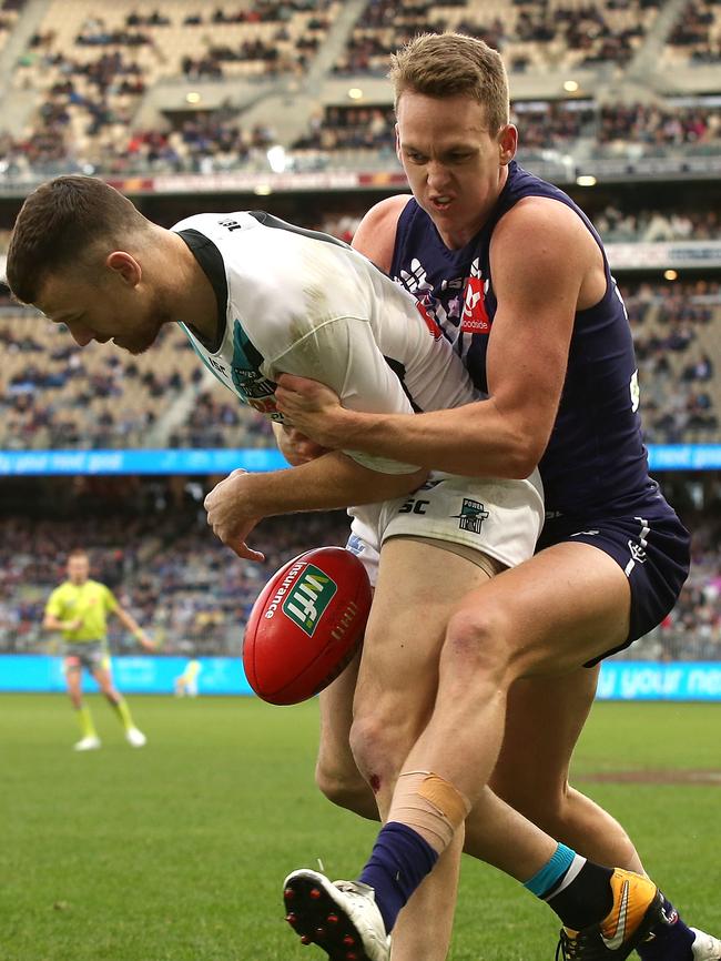 Ryan Nyhuis of the Dockers dumps Robbie Gray of the Power over the boundary at Optus Stadium. Picture: Paul Kane/Getty Images