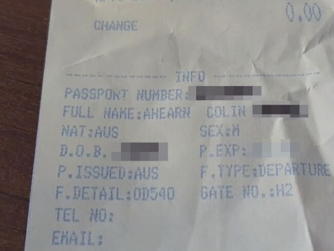 The receipt from hisduty-free purchase shows passport details printed on the paper.
