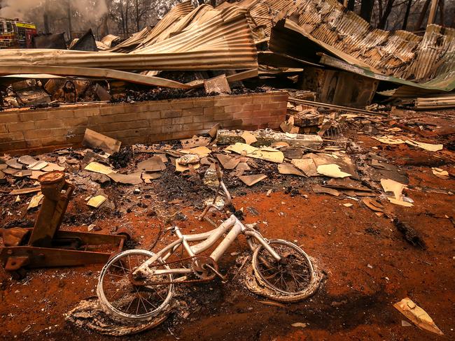 SYDNEY, AUSTRALIA - DECEMBER 21: A burnt bicycle lies on the ground in front of a house recently destroyed by bushfires on the outskirts of the town of Bargo on December 21, 2019 in Sydney, Australia. A catastrophic fire danger warning has been issued for the greater Sydney region, the Illawarra and southern ranges as hot, windy conditions continue to hamper firefighting efforts across NSW. NSW Premier Gladys Berejiklian declared a state of emergency on Thursday, the second state of emergency declared in NSW since the start of the bushfire season. (Photo by David Gray/Getty Images)