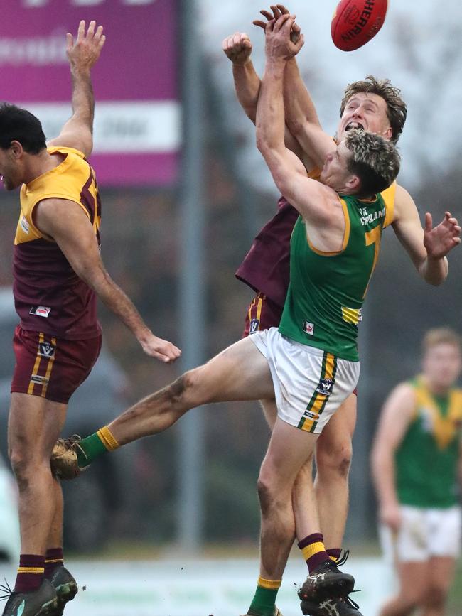 Leongatha’s Jackson Harry takes on two Drouin opponents.