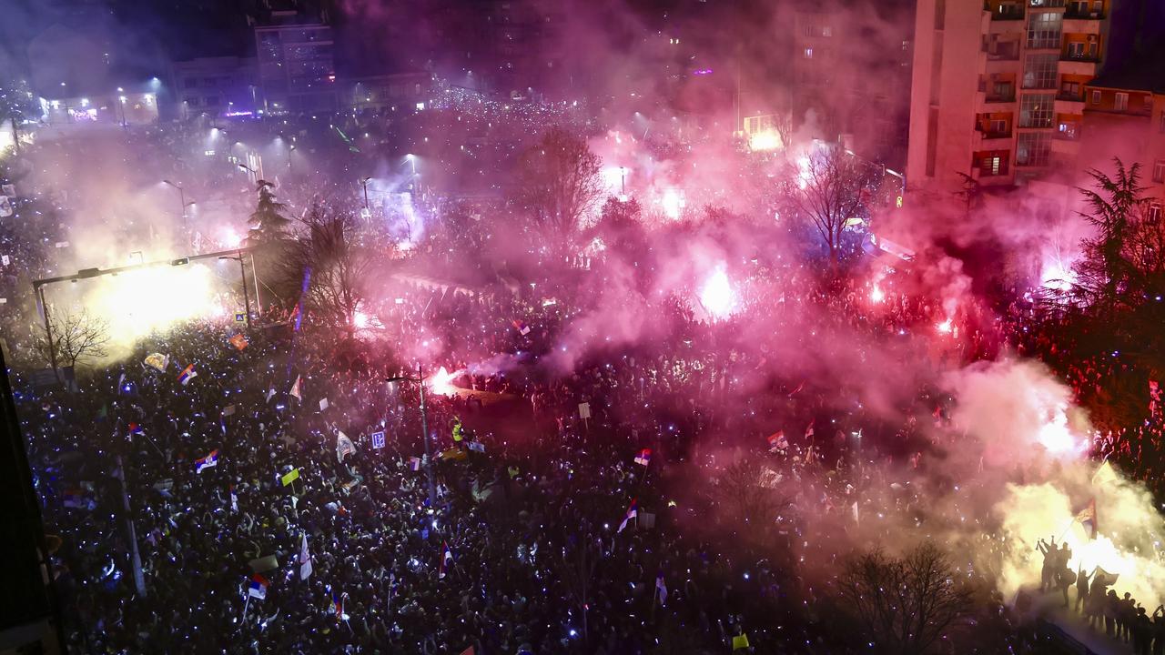 Protesters burn flares as thousands of people from all over Serbia gather to take part in one of the largest anti-corruption demonstrations. Picture: Srdjan Stevanovic/Getty