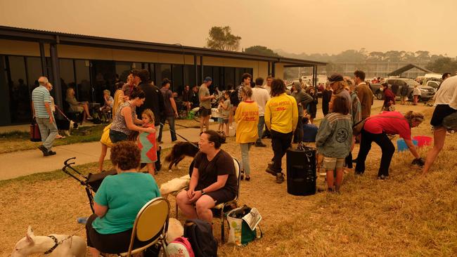 People gather at a relief centre at Malua Bay NSW, just south of Batemans Bay. Picture: Alex Coppel.