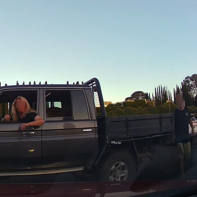 The male driver (pictured at the rear of the car) gave the pair a spray of his own after boxing them in with his LandCruiser. Picture: Dash Cam Owners Australia