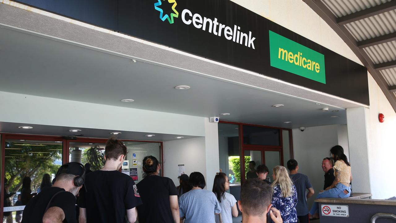 Lines of people wait at Southport Centrelink. Picture: Adam Head.