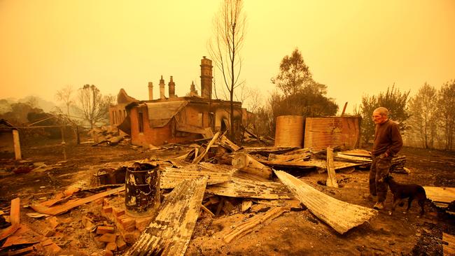 Malcolm Elmslie surveys the remnants of his house in Cobargo after a firestorm swept through the area last summer. Picture: Stuart McEvoy