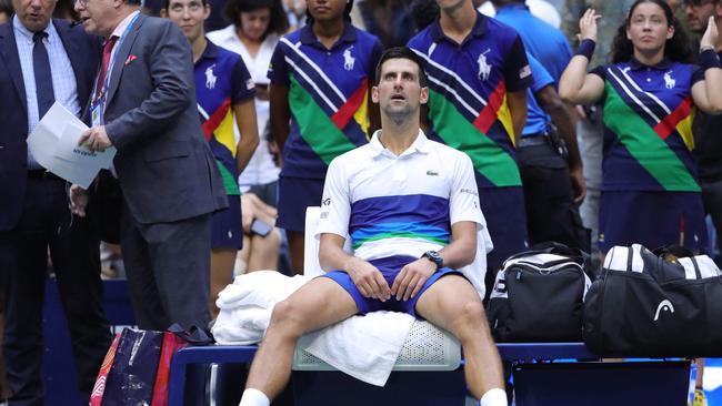 Serbia's Novak Djokovic sits in his courtside chair after losing the 2021 US Open final. Photo by Kena Betancur / AFP.