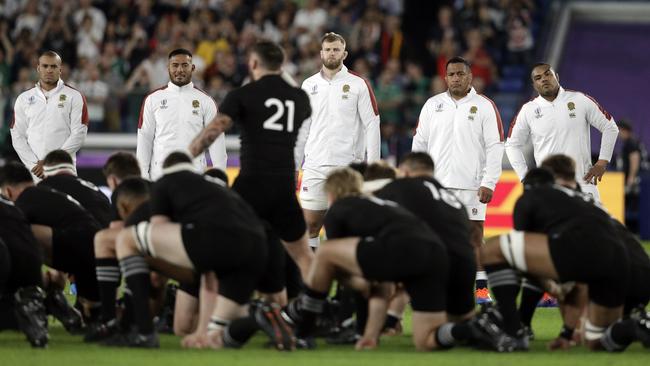 England players watch as New Zealand players perform the haka. Picture: AP