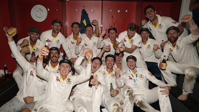 The Australian cricket team celebrate in the change rooms after Australia claimed victory to retain the Ashes at Old Trafford.