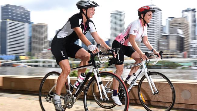 Melinda Brockhurst and Gabriella Roberts ride along the river in South Bank. Picture: AAP/John Gass