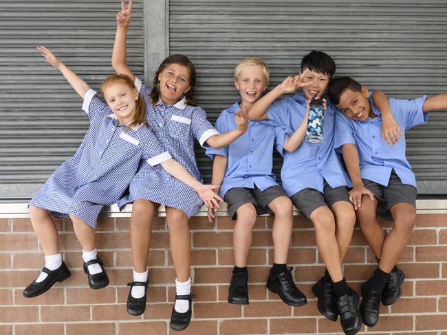 Multi ethnic children outside school with arms out and arms around each other posing for a photo Picture: Istock