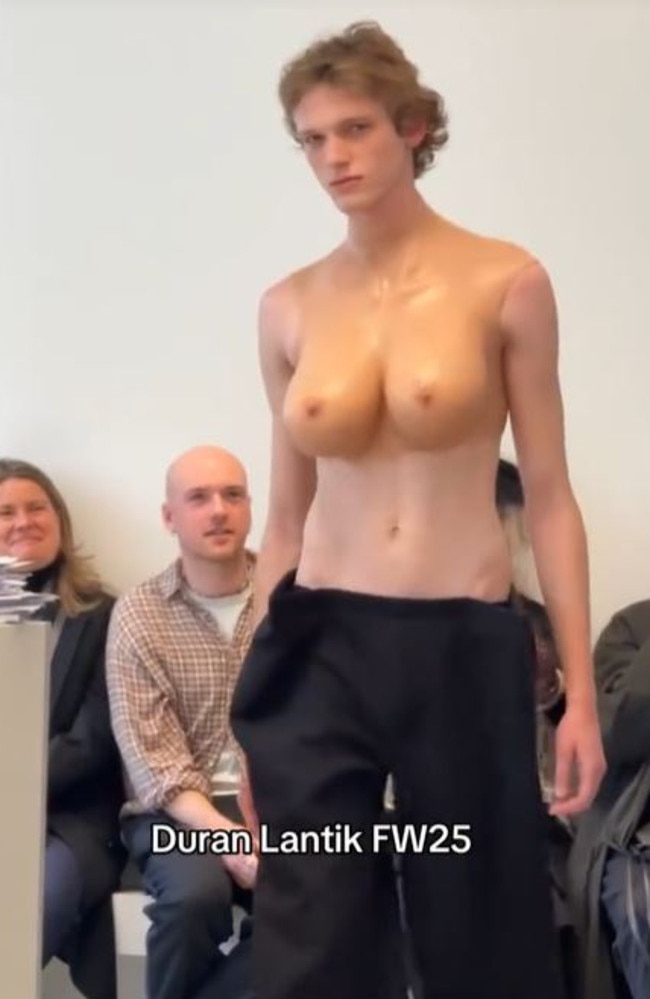 A male model strutted down the catwalk with fake breasts strapped to his chest. Picture: TikTok/becausemagazine