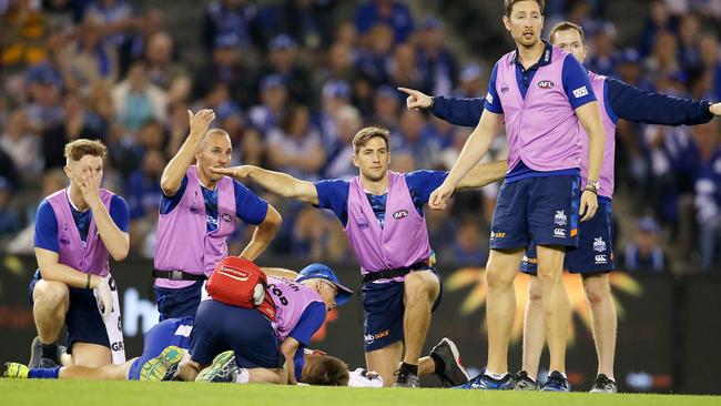 North Melbourne medicos attend to Shaun Higgins. Picture: Michael Klein