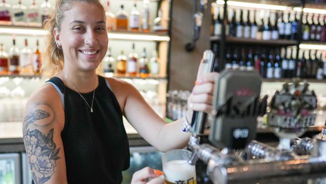 Copper Bar and Grill manager Tovah Wildman pulls a beer from the Cairns Esplanade restaurant on Thursday. Picture: Nuno Avendano