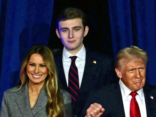 TOPSHOT - Former US President and Republican presidential candidate Donald Trump (R) arrives for  an election night event alongside former US First Lady Melania Trump and his son Barron Trump at the West Palm Beach Convention Center in West Palm Beach, Florida, on November 6, 2024. (Photo by Jim WATSON / AFP)