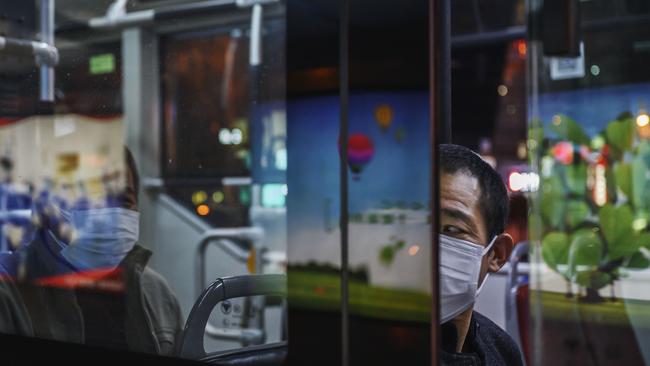 Chinese commuters on a bus in Beijing, China.