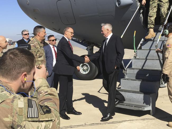 US Secretary of Defence Jim Mattis, centre, is greeted by US Ambassador Douglas Silliman as he arrives at Baghdad International Airport. Picture: AP Photo/Lolita Baldor