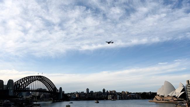 The last Qantas Boeing 747 airliner flies over the Sydney Harbour Bridge during its farewell flight to the US on Wednesday. Picture: Saeed Khan/AFP